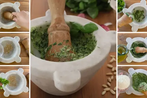 Preparazione del pesto fatto in casa: pestare aglio, sale, basilico, pinoli, parmigiano e olio d'oliva in un mortaio di marmo.