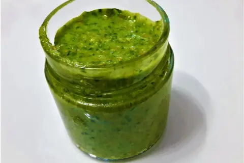 Un vasetto di pesto fatto in casa con il Bimby, pronto per condire la pasta.