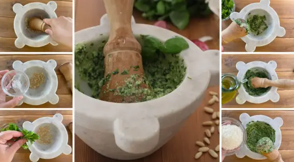 Preparazione del pesto fatto in casa: pestare aglio, sale, basilico, pinoli, parmigiano e olio d'oliva in un mortaio di marmo.