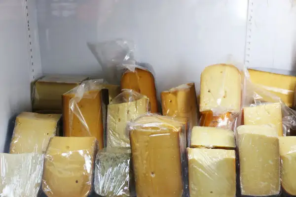 Vari tipi di formaggio confezionati singolarmente, pronti per capire come conservare il formaggio in frigo.