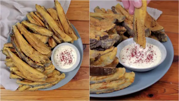 Piatto di melanzane fritte dorate e croccanti, servite con una ciotolina di salsa bianca cosparsa di spezie rosse. Una mano intinge una bastoncino di melanzana nella salsa.